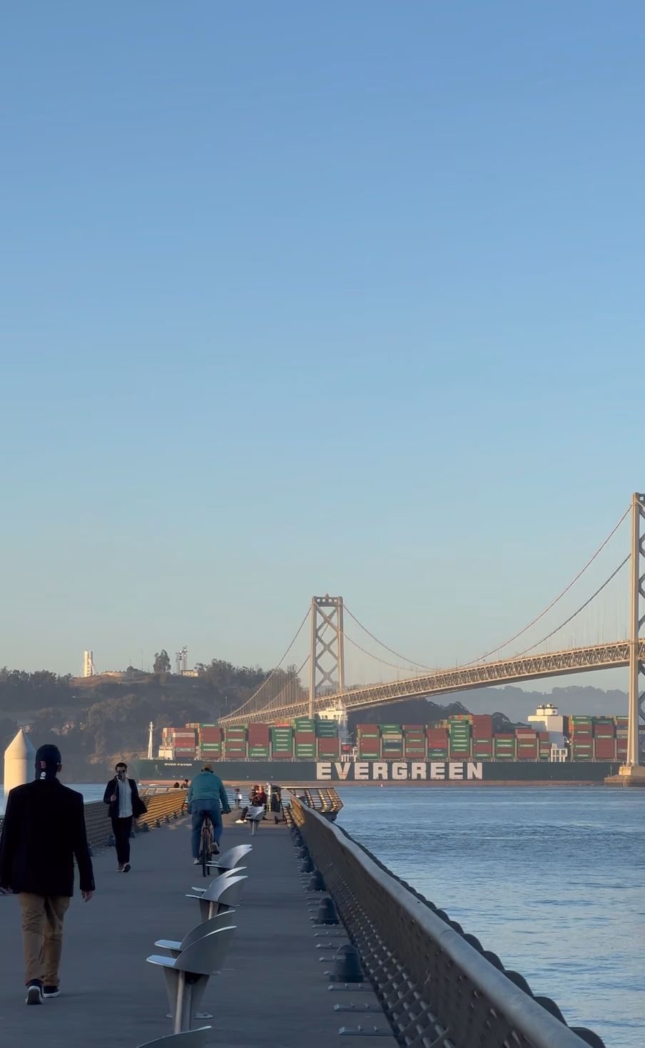 The Embarcadero pier with the Bay Bridge and a container ship in the background